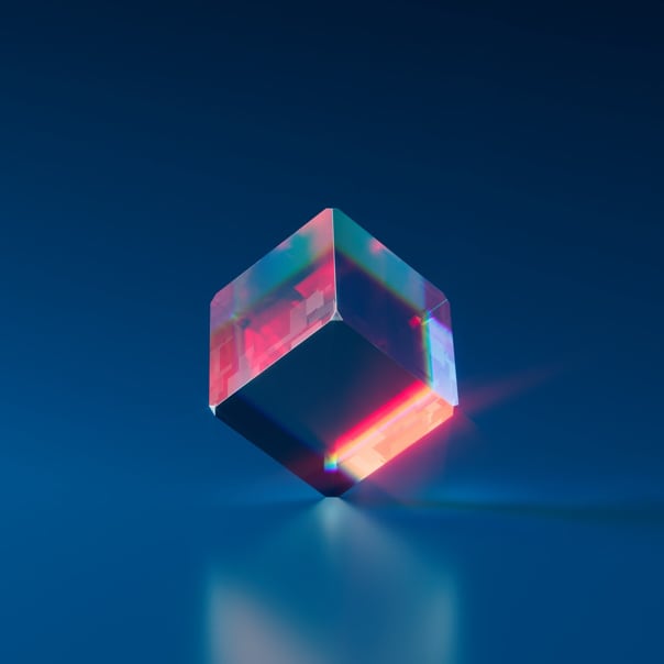 glass cube standing on its corner atop a flat smooth surface, symbolising equilibrium obviously